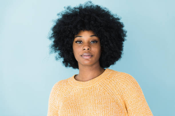 The serious, strong woman looks at the camera for her photo to be taken.